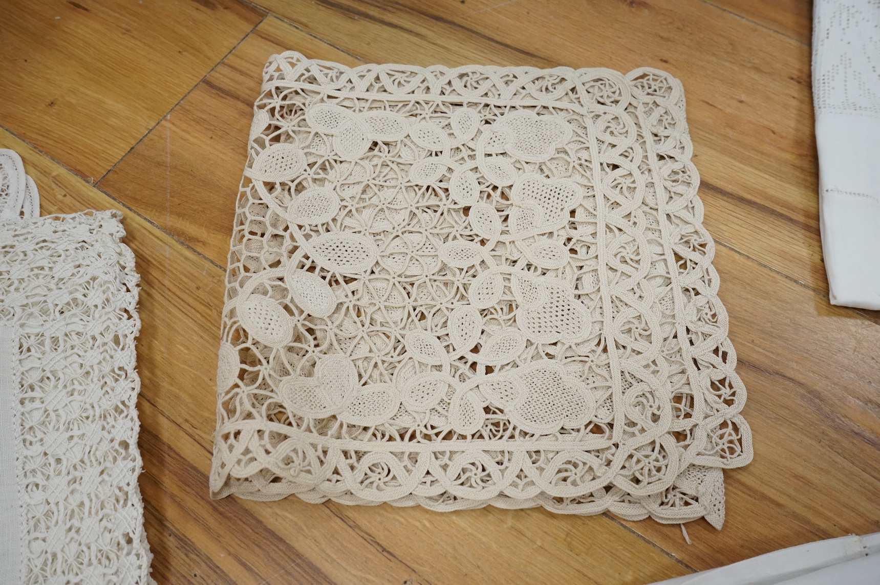 A collection of early 20th century and later crochet, cut work and drawn thread table linens and a large embroidered table cloth